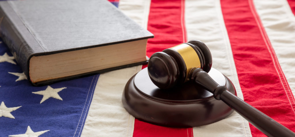 Law gavel and book on United States of America flag.